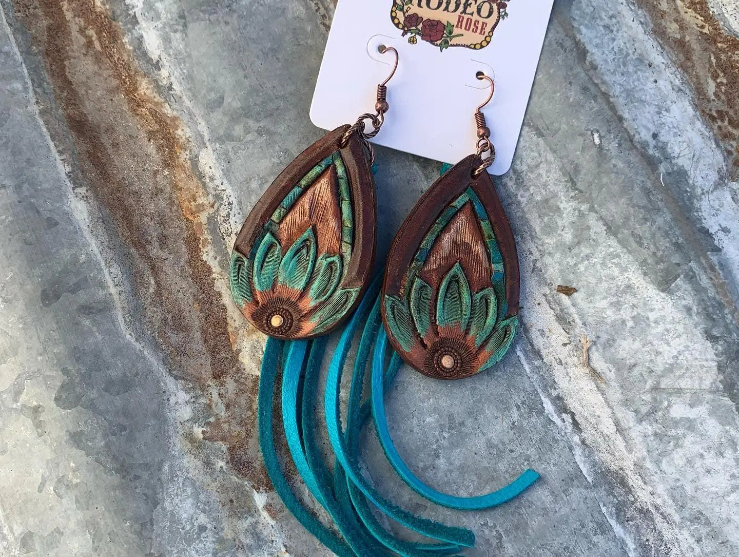 The Tad Hand Tooled Leather Earrings with Turquoise Border and Turquoise Deerskin Fringe The Rodeo Rose